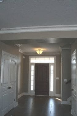 Hallway entrance leading into common area and kitchen