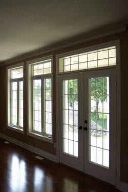Large panel windows and a window paneled door leading outside