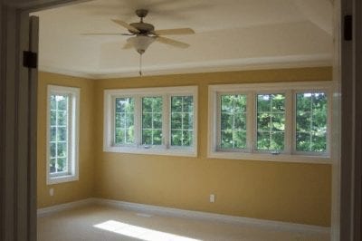 An empty room with a ceiling fan