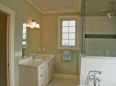 Large glass wall shower with bathtub beside it in a bathroom