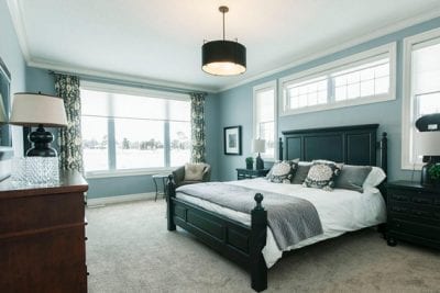 Master bedroom with a bed and large window