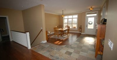 Dining area near front door entrance with stairs leading down